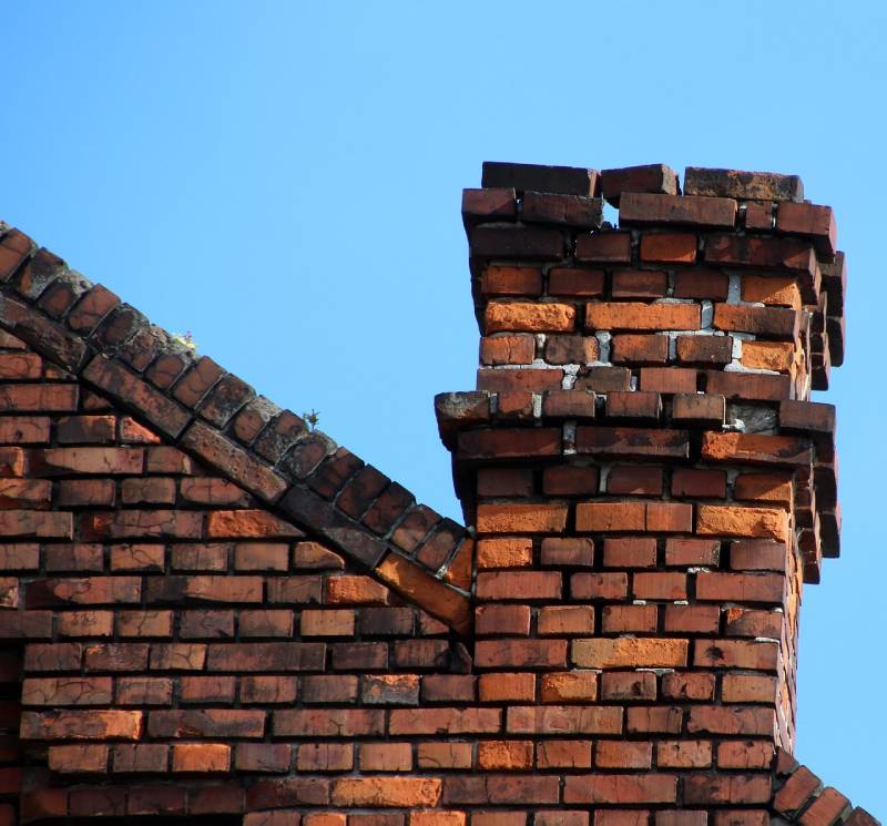 Damaged chimney on an Bonita home showing cracks and missing mortar